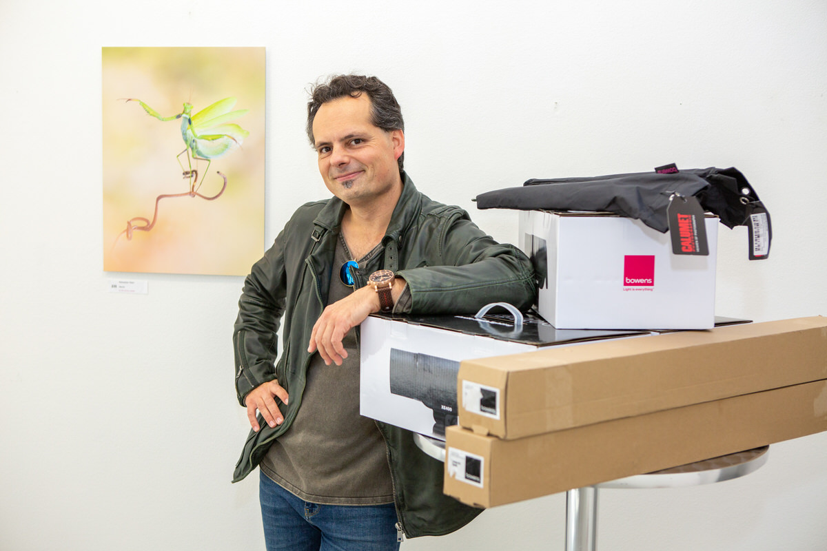 One of the winners at the SPC Photo Awards - Stuttgart, posing with his photo and his prizes